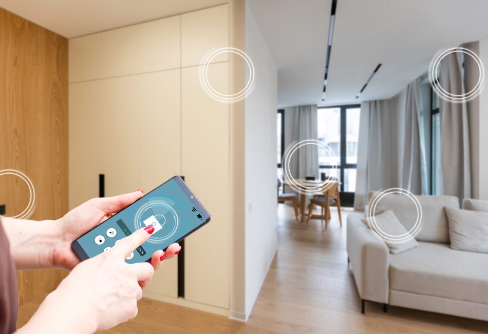 Home temperature, safety and environment control on mobile app. Smart phone in woman hand. Living room in background.